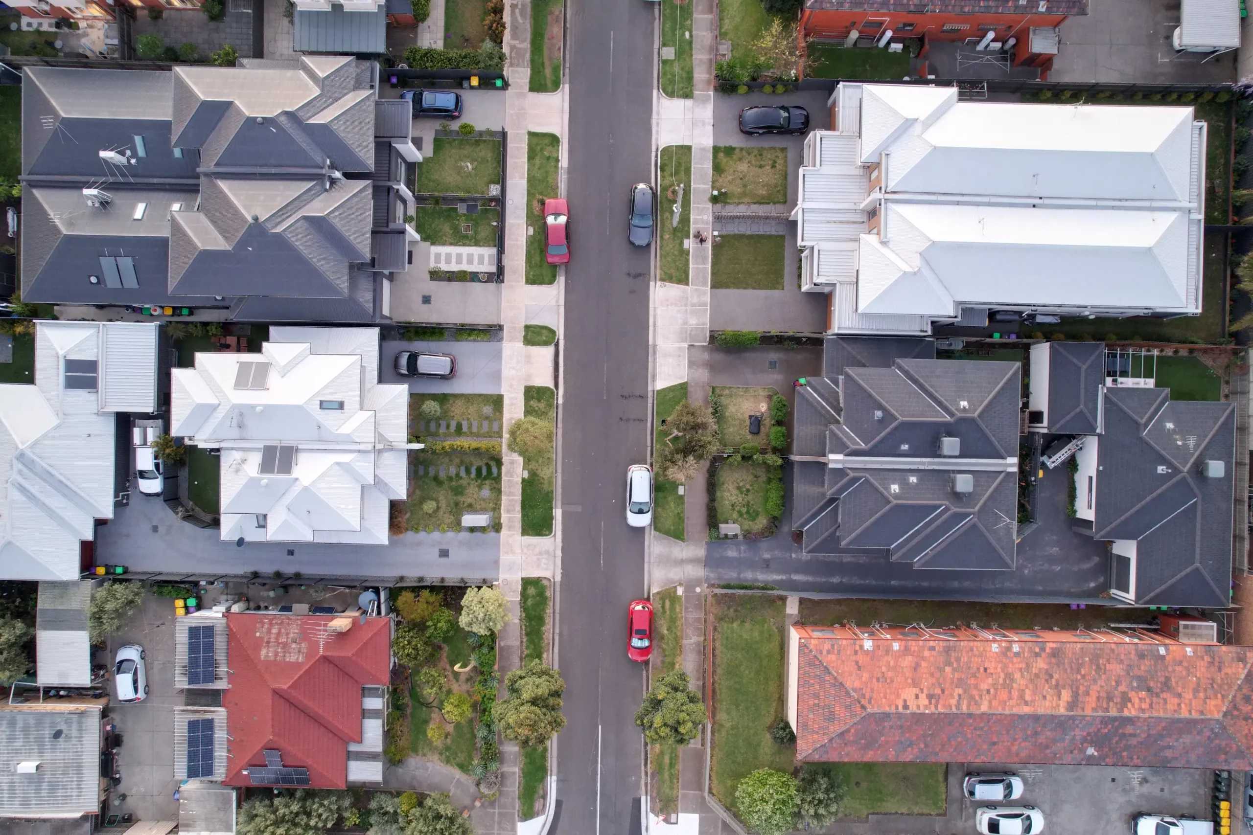 drone-photo-looking-down-onto-houses-with-a-stree-2023-11-27-04-52-22-utc